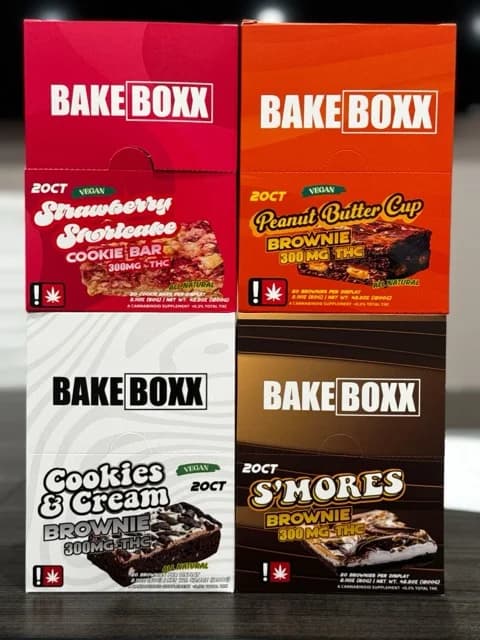 Edibles Image, four variations of our BakeBoxx THC Brownie boxxes. Showing Strawberry Shortcake, Peanut Butter Cup, Cookies & Cream, S'Mores. 20 count boxes, all 300mg